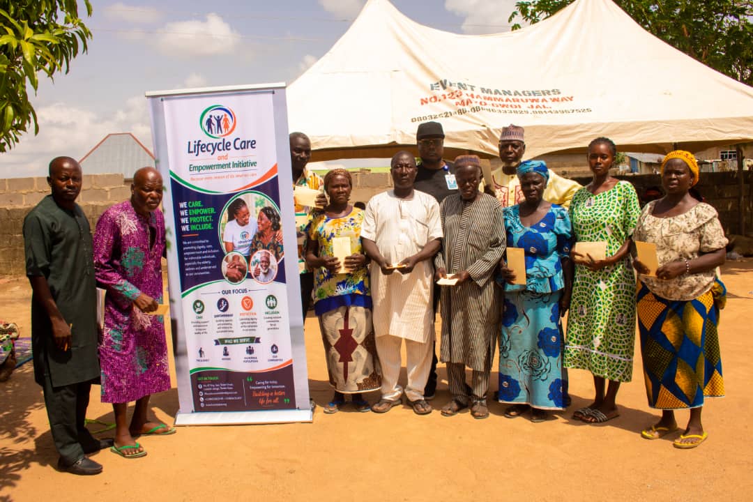 Selected community members and beneficiaries standing together after validation